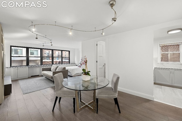 dining space with wood-type flooring