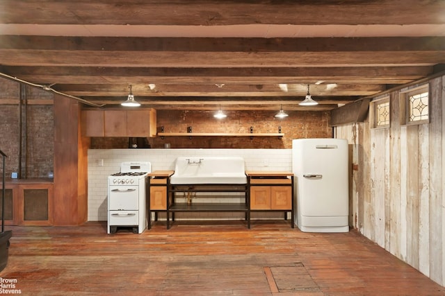 interior space with dark hardwood / wood-style flooring, sink, and refrigerator