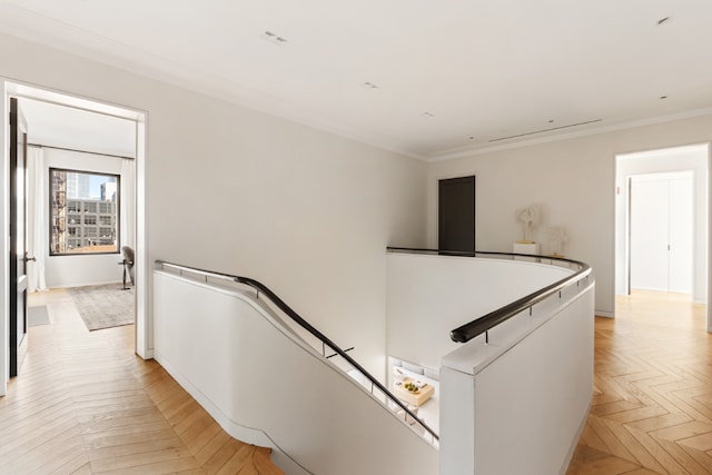 hallway featuring light parquet flooring and ornamental molding