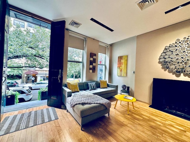 sitting room featuring a wealth of natural light, a fireplace, and hardwood / wood-style floors