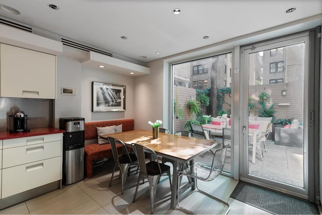 dining space featuring a wealth of natural light and light tile patterned flooring