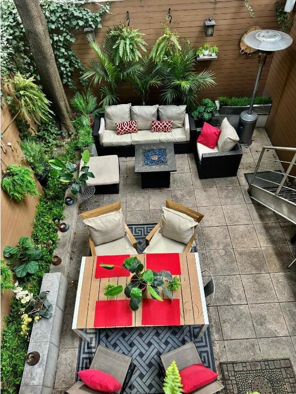 balcony featuring an outdoor living space with a fire pit and a patio area