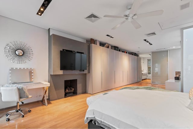 bedroom with ceiling fan and hardwood / wood-style flooring