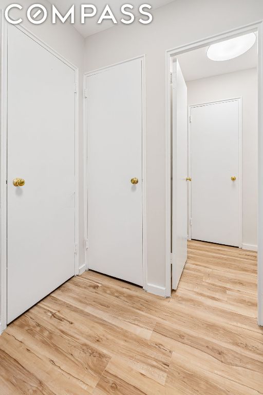 corridor with light hardwood / wood-style floors