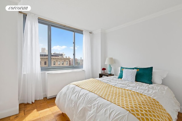 bedroom with light tile patterned floors and ornamental molding