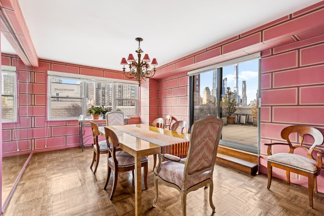 dining room featuring parquet flooring, a wealth of natural light, beamed ceiling, and a chandelier