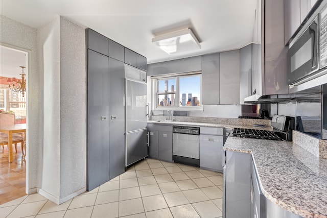 kitchen featuring light tile patterned floors, gray cabinets, range, stainless steel dishwasher, and sink