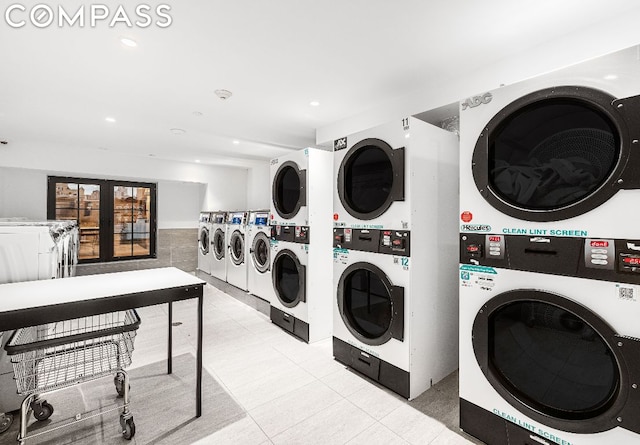 laundry area with stacked washing maching and dryer, light tile patterned floors, and separate washer and dryer