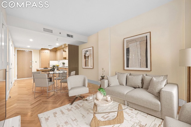 living room with light parquet flooring and sink