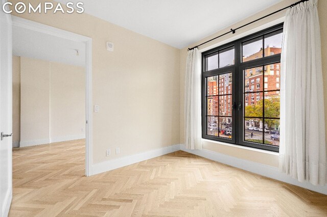 unfurnished room with light parquet floors