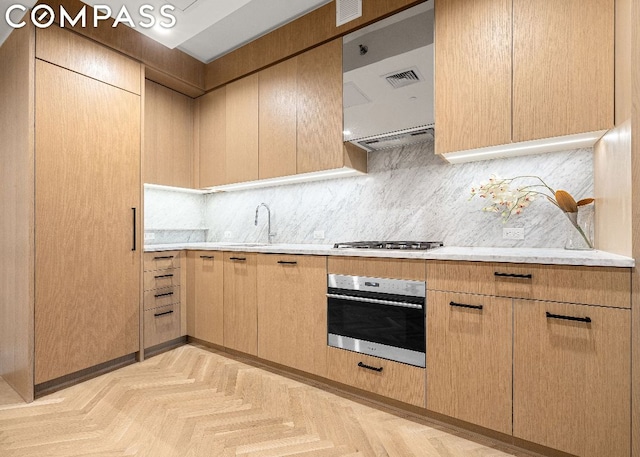 kitchen with backsplash, sink, light brown cabinets, and stainless steel appliances