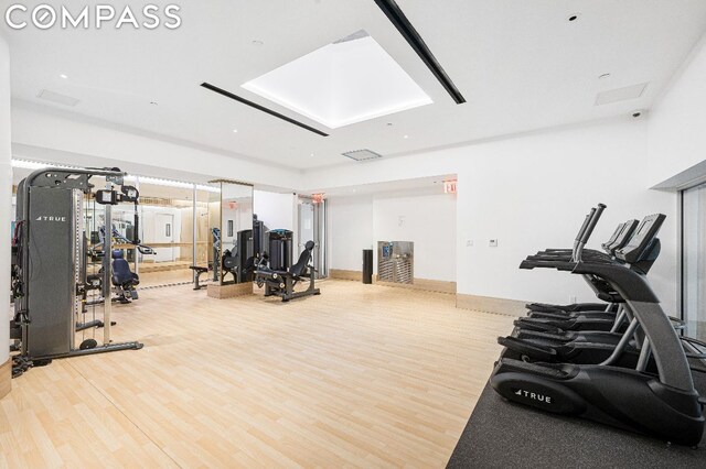 exercise room with hardwood / wood-style floors