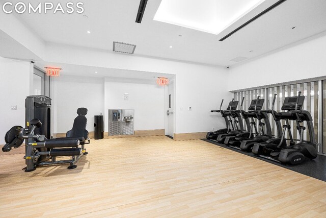 exercise room with wood-type flooring