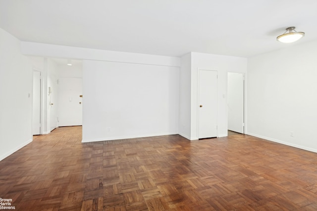 spare room with baseboards