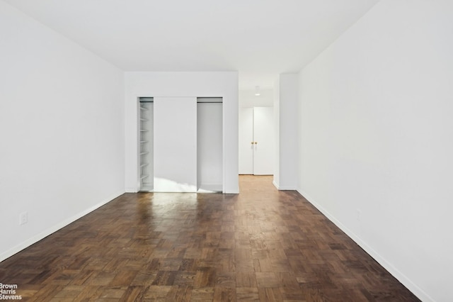 unfurnished bedroom featuring a closet and baseboards