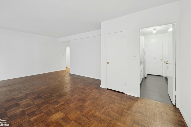 unfurnished room with dark parquet floors