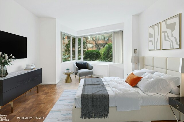 bedroom with dark parquet floors