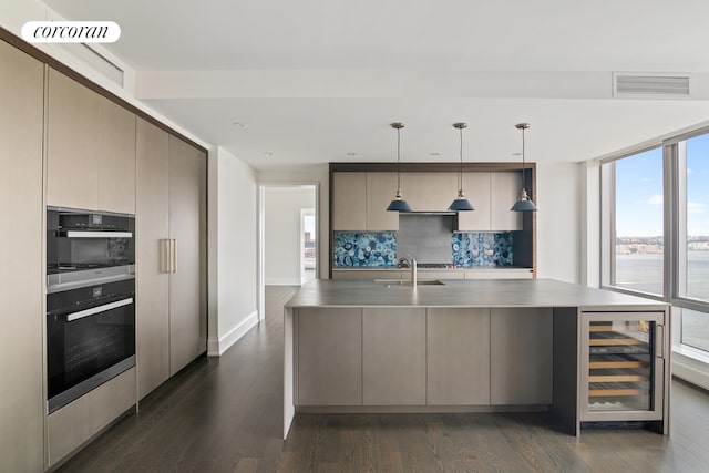 kitchen with beverage cooler, decorative light fixtures, backsplash, dark hardwood / wood-style floors, and a water view