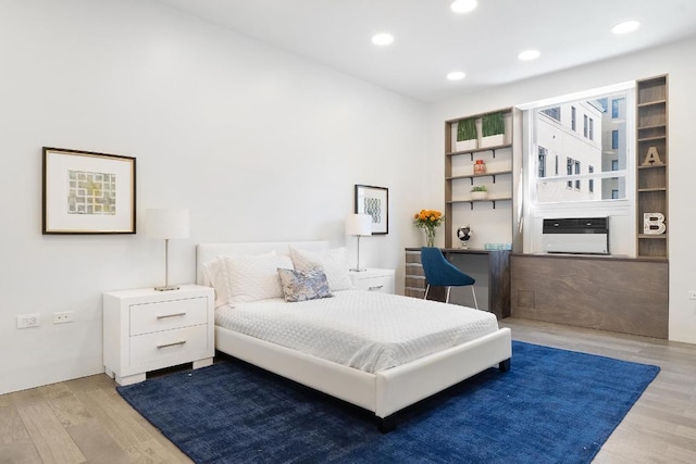 bedroom featuring wood finished floors and recessed lighting