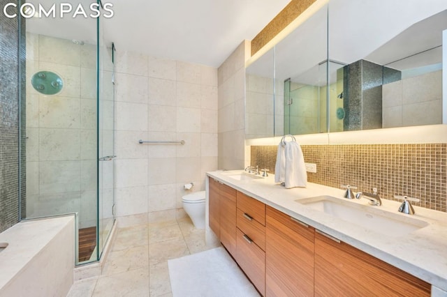 bathroom with toilet, tile walls, an enclosed shower, and vanity