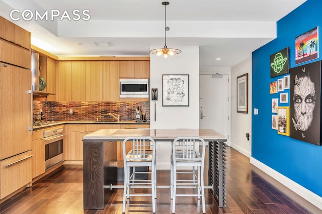 70 Little W St Unit 15A, New York City, NY 10004 - kitchen with built in appliances, dark wood-style floors, modern cabinets, decorative backsplash, and recessed lighting