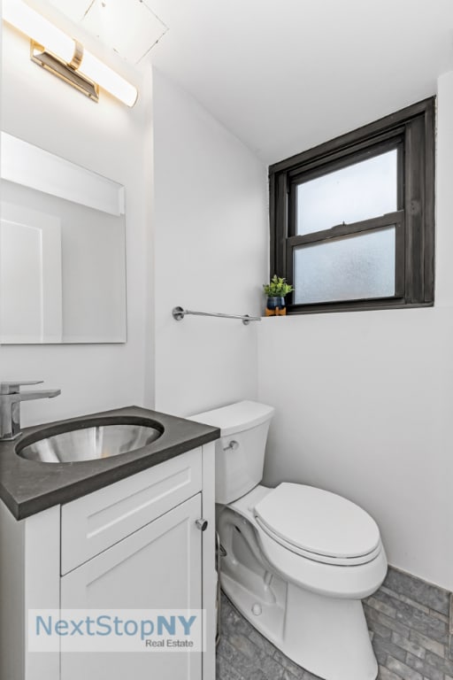 bathroom with toilet and vanity