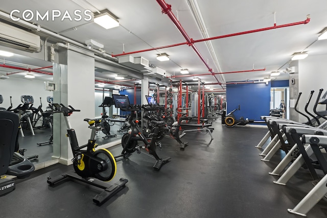 exercise room featuring an AC wall unit