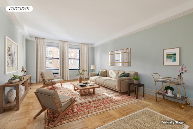 living room featuring ornamental molding and light parquet flooring