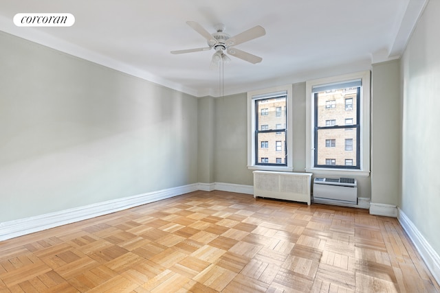 spare room with visible vents, baseboards, a ceiling fan, radiator heating unit, and heating unit