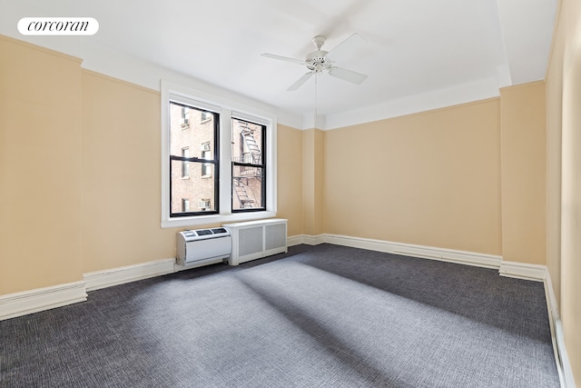 empty room featuring ceiling fan, baseboards, visible vents, and dark carpet