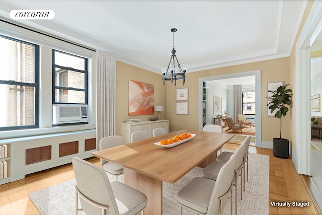 dining area with radiator, a healthy amount of sunlight, crown molding, and visible vents