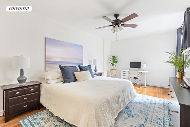 bedroom with ceiling fan and light hardwood / wood-style floors