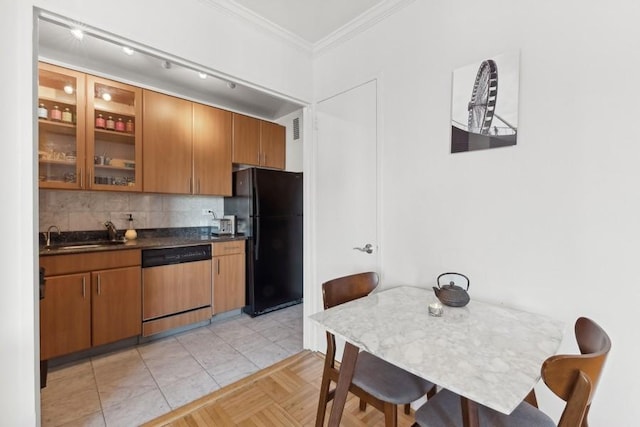 kitchen featuring black refrigerator, dishwashing machine, tasteful backsplash, crown molding, and sink