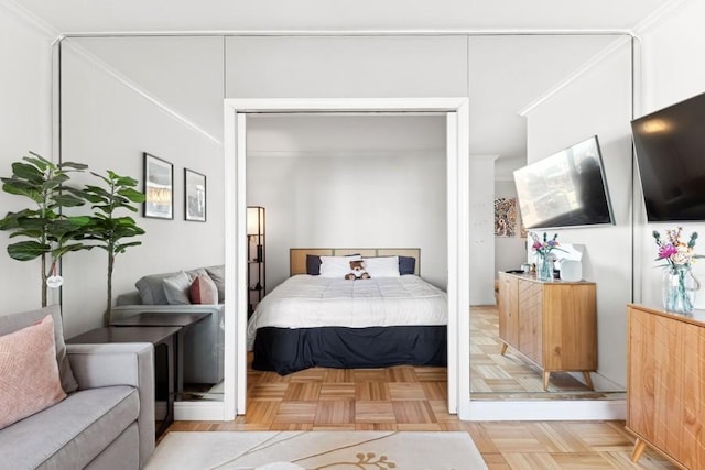 bedroom with light parquet floors and a closet