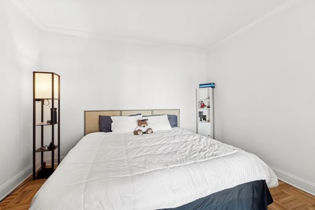 bedroom with ornamental molding and parquet flooring