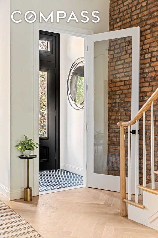 entrance foyer featuring stairway and baseboards