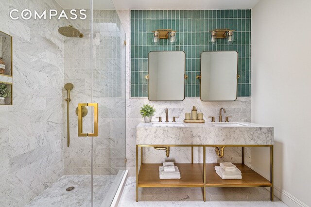 full bathroom with tiled shower and a sink