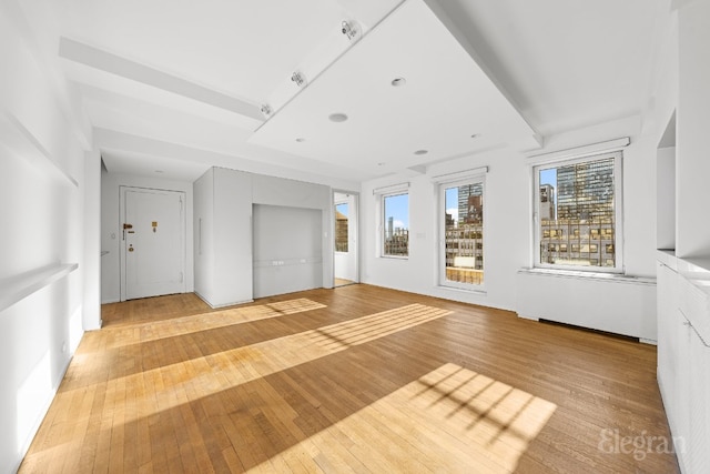 unfurnished living room with light wood-type flooring