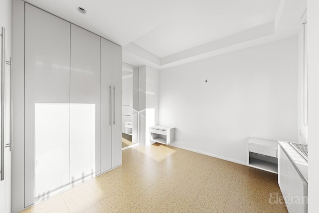 interior space with a closet and a raised ceiling