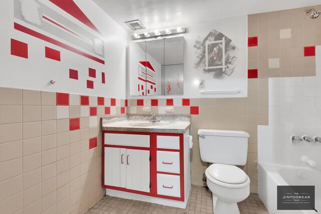 bathroom with toilet, vanity, tile walls, and a tub