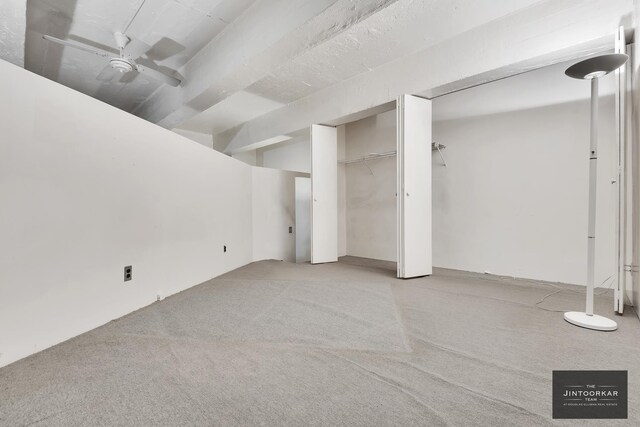 529 W 42nd St Unit 5M, New York City, NY 10036 - basement with light carpet and ceiling fan