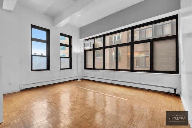 spare room with light parquet flooring, a baseboard heating unit, and a wall mounted air conditioner