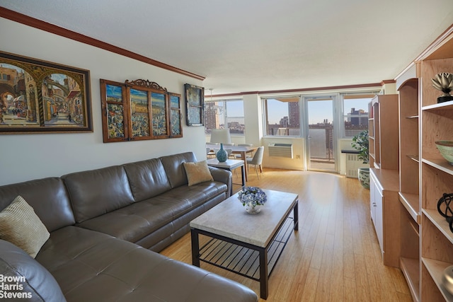 living room featuring light wood-type flooring and crown molding