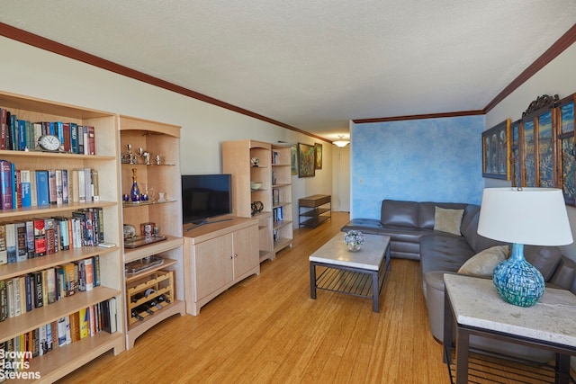 living room with a textured ceiling, ornamental molding, and light hardwood / wood-style floors