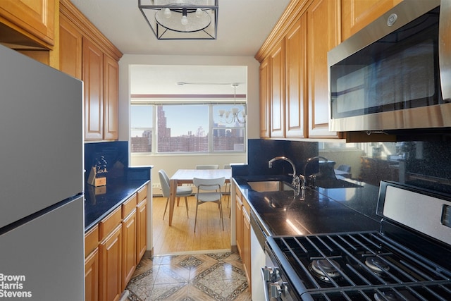 kitchen with stainless steel appliances, tasteful backsplash, and sink