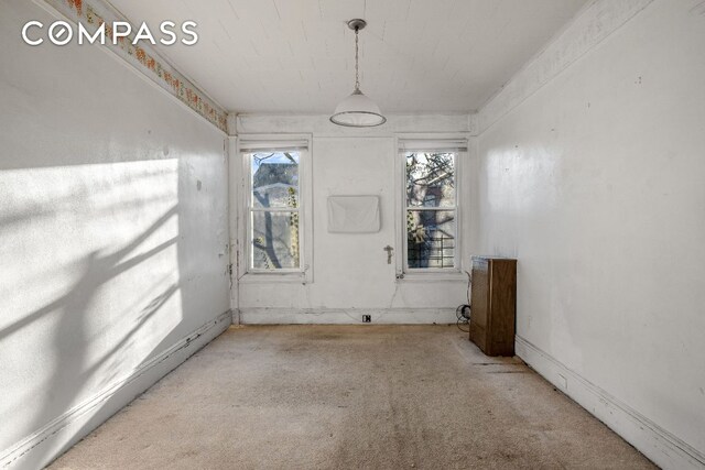 interior space featuring parquet floors, radiator, and decorative columns