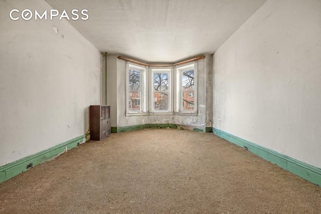 empty room with a wealth of natural light, ceiling fan, and parquet floors