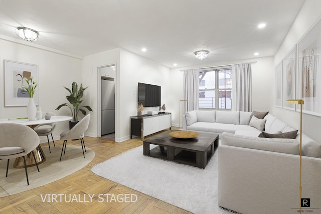 living room featuring baseboards and recessed lighting