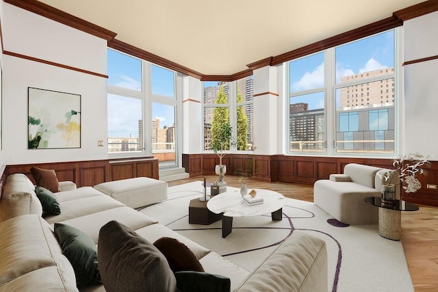 living area with a wainscoted wall, a view of city, and light wood finished floors