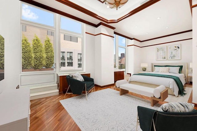 bedroom featuring crown molding, baseboards, and wood finished floors